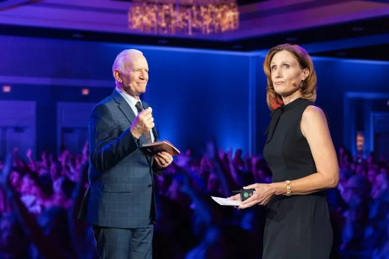 Carl and Cathie Firestone speaking on stage at a LifeWave leadership event