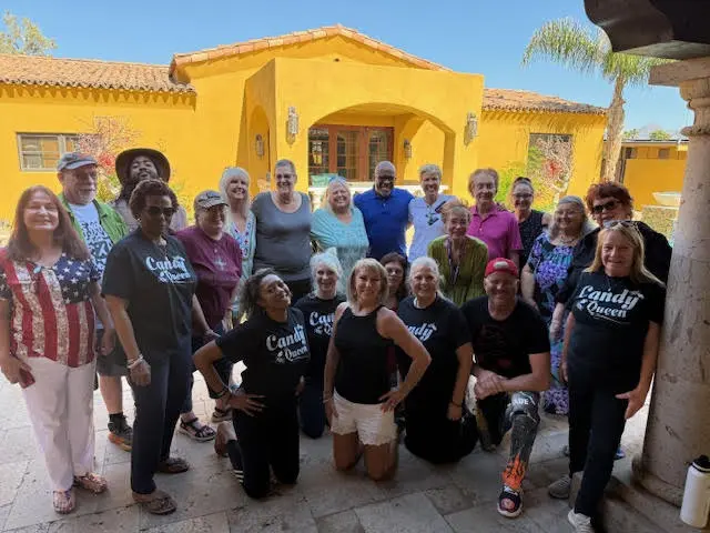 Group photo of attendees gathered outside a retreat venue.