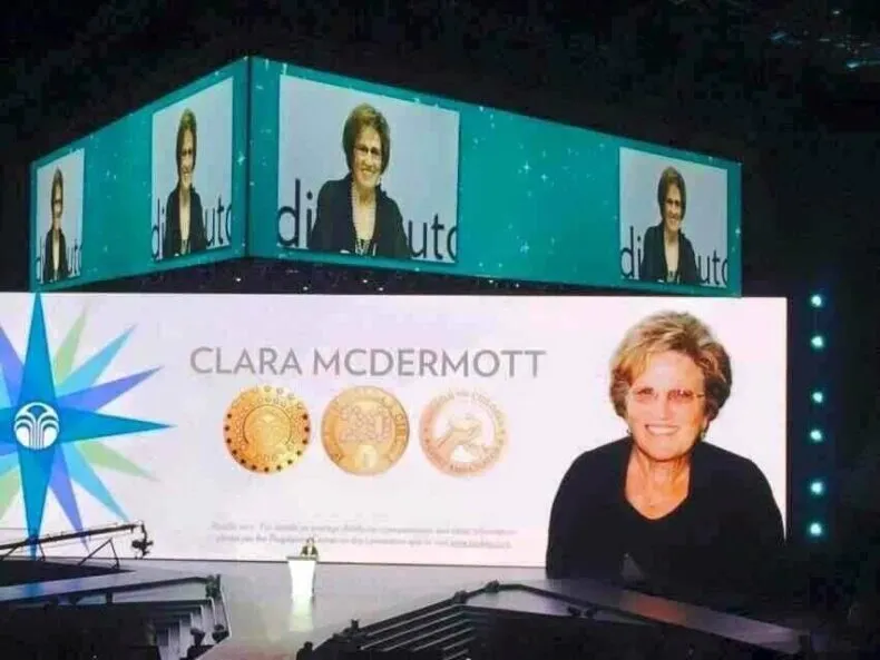 Clara S. McDermott, Nu Skin pioneer and industry icon, speaks on a Nu Skin stage. She will be forever remembered for her leadership, vision, and impact on network marketing.