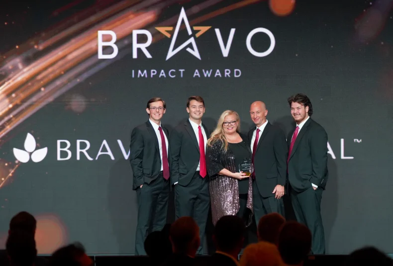 Bravenly Global team receiving the Bravo Impact Award at the DSN Global 100 Celebration