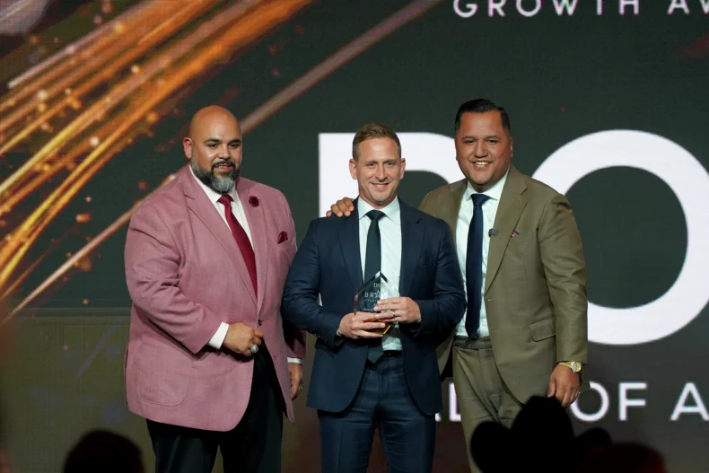 Realty of America team receiving the Bravo Growth Award at the DSN Global 100 Celebration