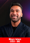 The CEO of the BE Club, Moyn Islam, in a suit, smiling.