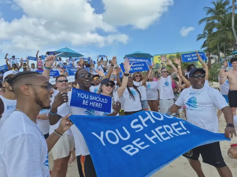 DreamTrips members celebrating together on a Bahamas beach during the 20th anniversary relaunch cruise