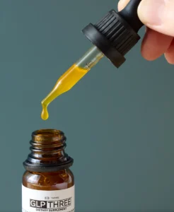 Close-up of GLP THREE liquid metabolic wellness supplement