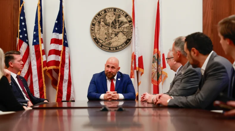 Florida Lieutenant Governor Jay Collins speaking with FLDSCC attendees about entrepreneurship