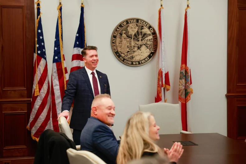 Ryan Chamberlin speaking at Florida Direct Selling Coalition meeting with direct selling leaders and officials