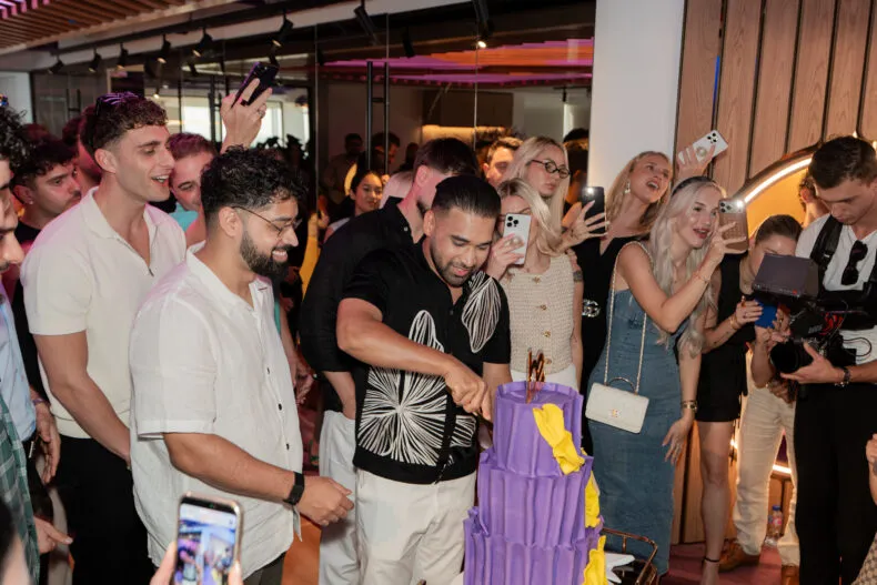 BE leaders and affiliates celebrate at the Dubai headquarters tour as a cake is cut during the Sapphire Retreat.