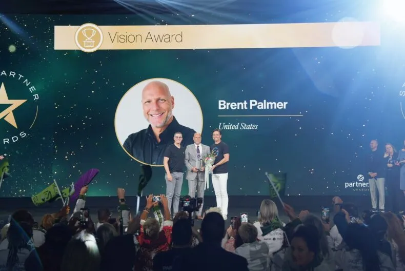 Brent Palmer on stage receiving the Partner.Co 2025 Vision Award at PXP’25 Dallas.