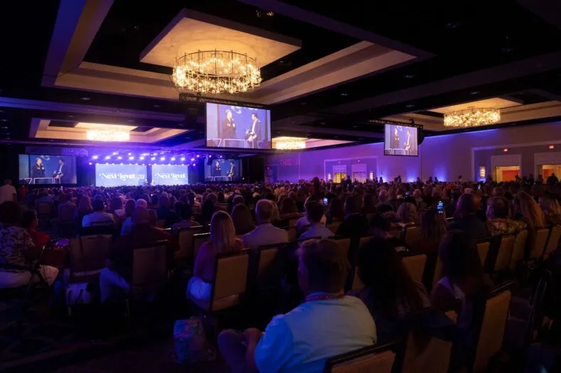 David Schmidt speaking on stage at the NEXT LEVEL Convention hosted by the THIS IS IT Team