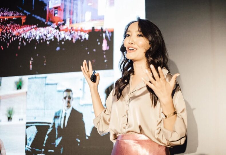 Fariza Kellerman speaking on stage during an MWR Life leadership event