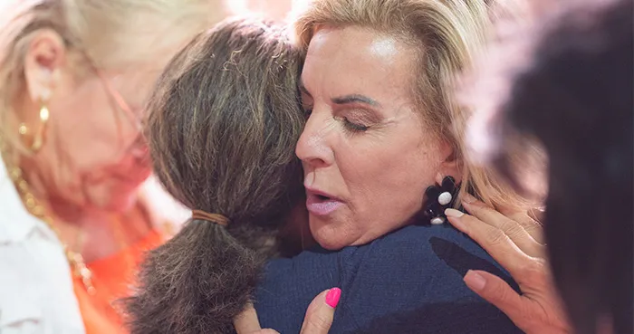 Gina Merritt praying with an attendee