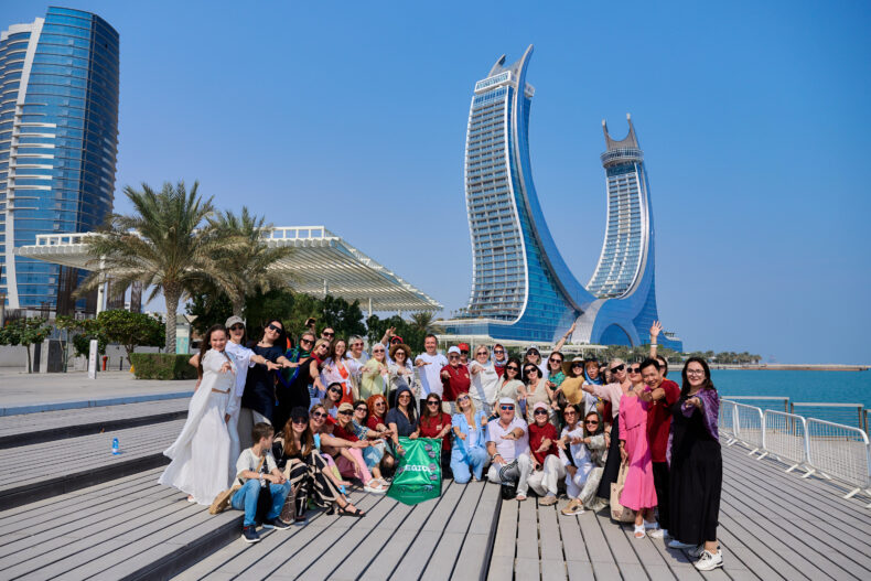 Greenway Global partners posing outdoors in Doha with the iconic Lusail Towers behind them
