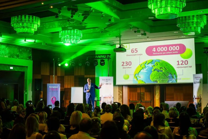 Greenway executive Andrej Khilkevitch on stage with European Tour stats projected behind him during a Slovakia event.