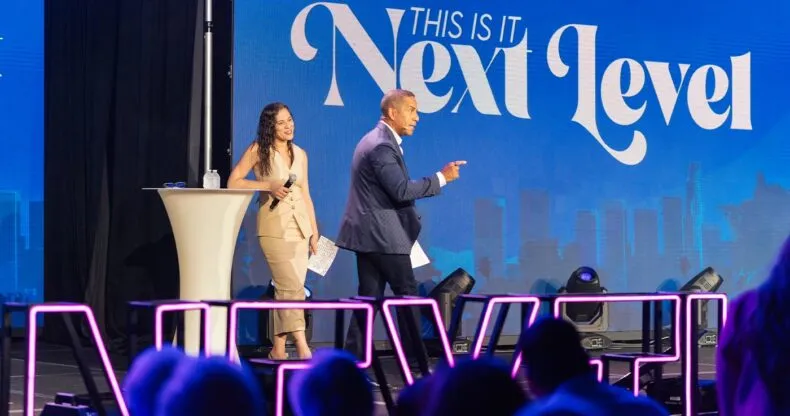 Mike and Sahi Hernandez speaking on stage during the THIS IS IT Next Level event for LifeWave leaders
