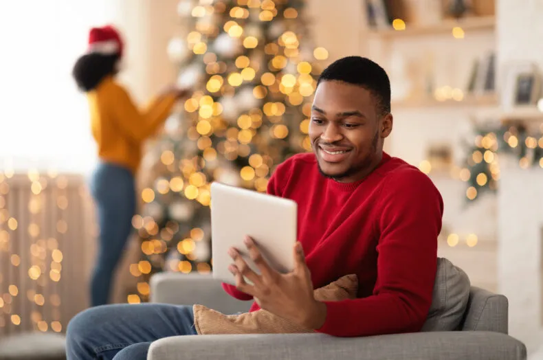 Man using a tablet at home during the holidays