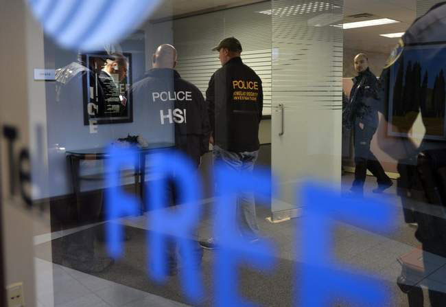 Homeland Security Investigations agents raid TelexFree in Marlborough. Daily News Staff Photo / Allan Jung