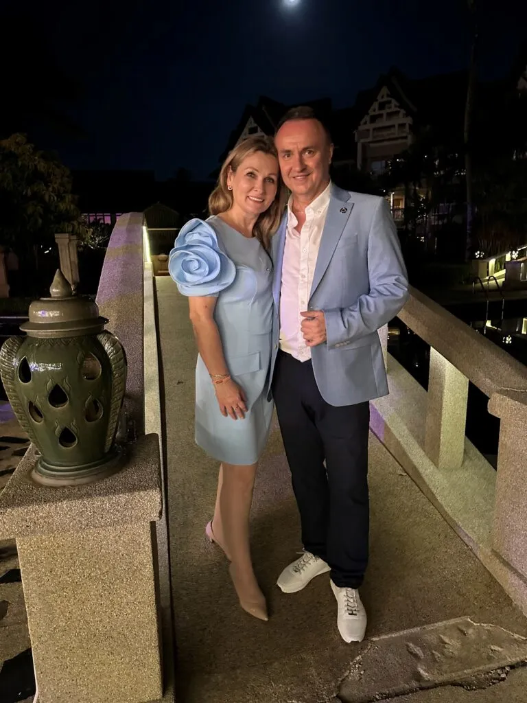 János Sztruhár and his wife standing together on a bridge at night under the moonlight.