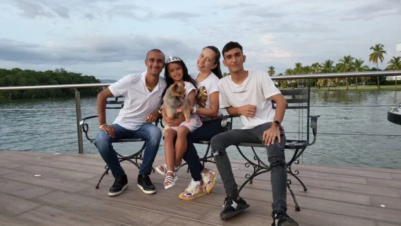 Javier Ortiz with his family sitting by the water in Latin America