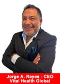 Jorge A. Reyes, CEO of Vital Health Global, smiling with arms crossed in a black blazer