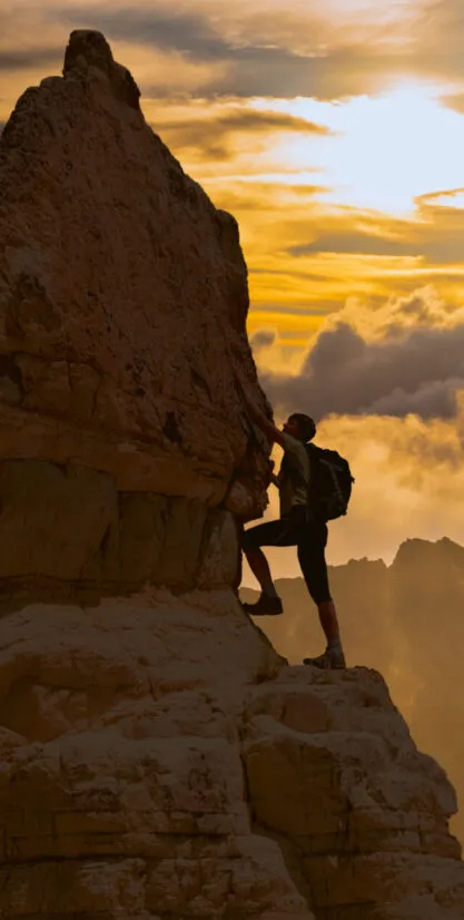 Person climbing a mountain representing leadership growth through discipline