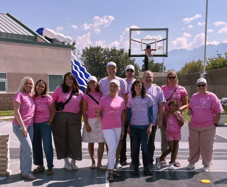 Love Three community members wearing pink Love Three shirts during a THREE International impact initiative