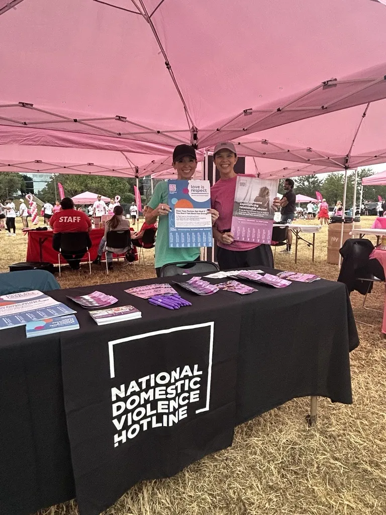 Representatives at a National Domestic Violence Hotline information table during Mary Kay MK5K 2026