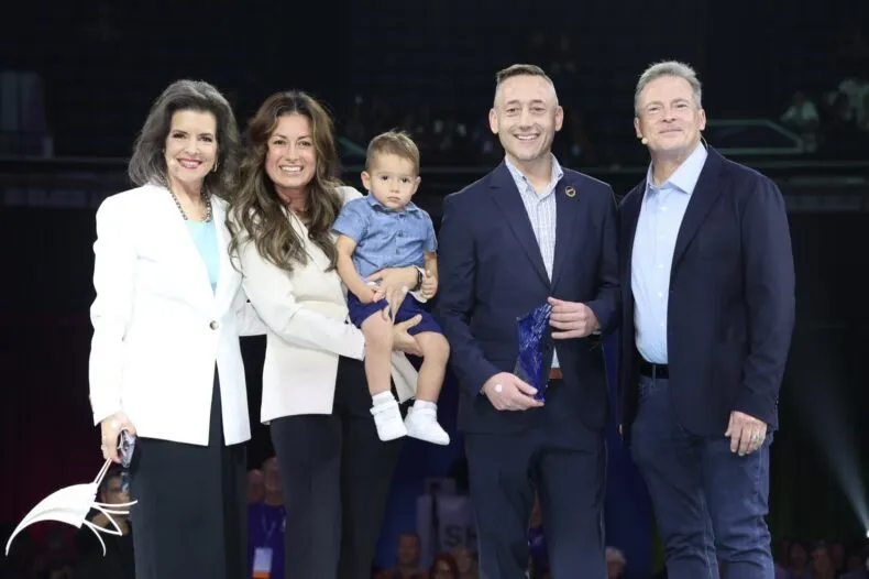 Michal and Lucia Blaszkowski on stage with Founder David Schmidt and President Meredith Berkich at LifeWave event.