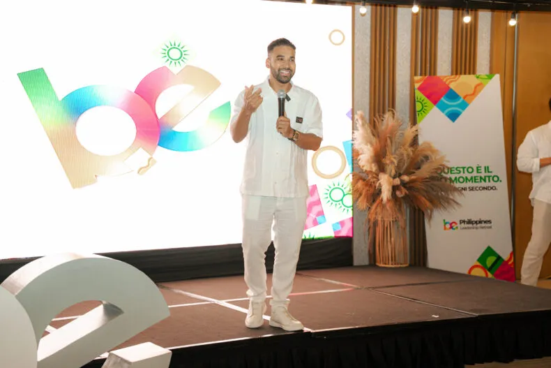 Moyn Islam speaking on stage at the BE Leadership Retreat in the Philippines