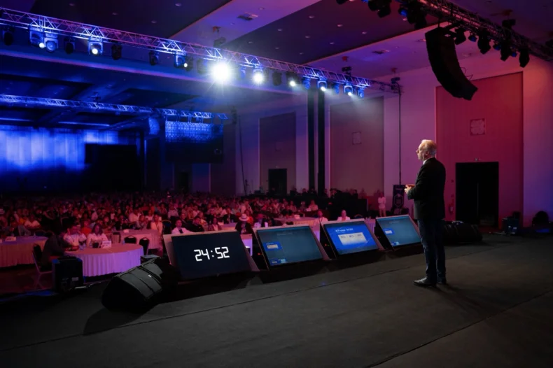 MWR Life leadership trainer speaking to a large audience during an international Bootcamp