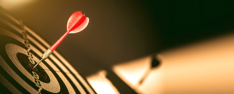 Dart hitting the center of a target symbolizing focus and clarity in business decisions