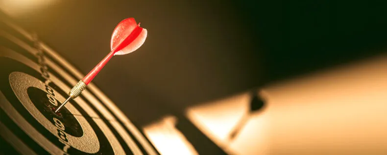 Dart hitting the center of a target symbolizing focus and clarity in business decisions