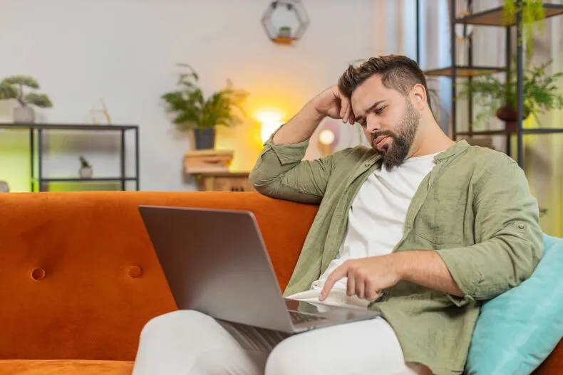 Network marketing professional evaluating business performance on laptop