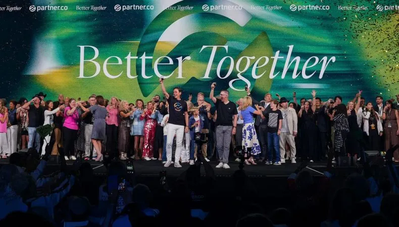 Partner.Co leaders and Brand Partners celebrate together on stage during the “Better Together” global event.