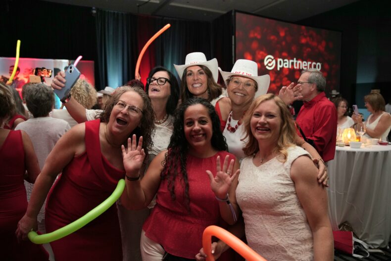 Group of female Brand Partners dressed in red and white at Partner.Co Connect Calgary