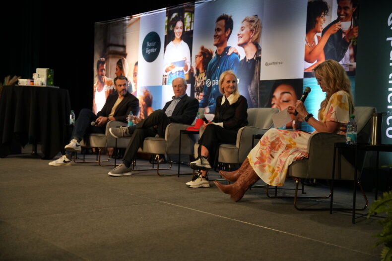 Partner.Co executives onstage in discussion at Connect Calgary 2025