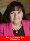 Penny Carpenter, Senior Presidential Director at LifeWave, smiles in a professional headshot wearing a pink blazer.