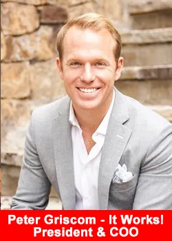 Peter Griscom smiling in a light gray suit, seated on outdoor stone steps, newly appointed President and COO of ItWorks.