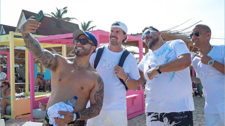 The Code leaders taking a group selfie on the beach during the Sapphire Trip