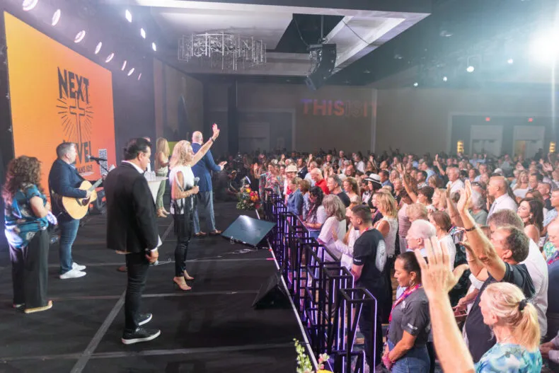 Attendees participate in a church service during the NEXT LEVEL Convention