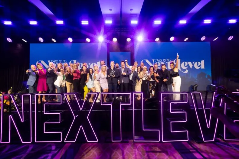 Leaders celebrating on stage at the NEXT LEVEL Convention hosted by the THIS IS IT Team
