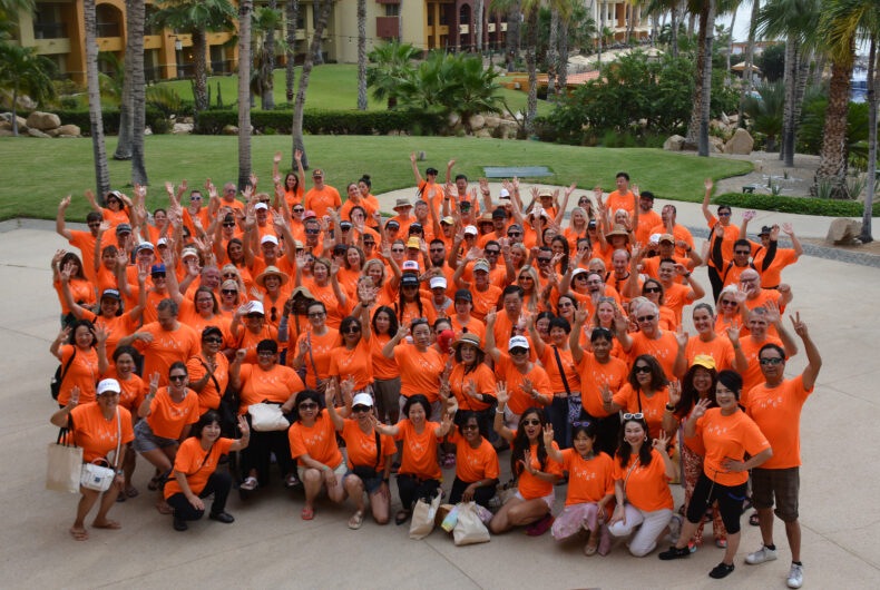 THREE Brand Ambassadors wearing orange shirts posing together during the Cabo San Lucas 2025 incentive trip