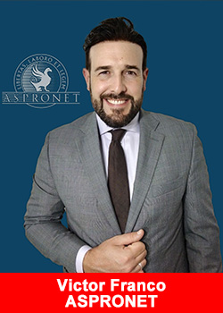 Victor Franco, Chairman of ASPRONET, in a formal grey suit with ASPRONET logo in the background