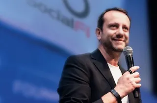 Vyvo executive speaks into a microphone on stage with SocialFi branding in the background.