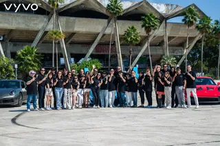Vyvo Global Members at Outdoor Event with Supercars