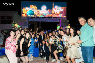 Vyvo leaders pose together under a digital billboard featuring the Vyvo logo and Las Vegas graphics.