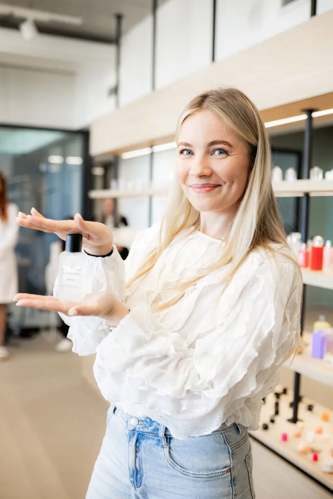 Yulia Arsenteva of Latvia holding her signature perfume bottle during the Greenway Global Enjoy Care factory masterclass in Brno.