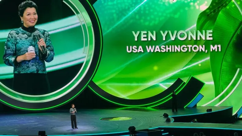 Yvonne Yen delivering a keynote speech at Greenway Global event in Washington, showcasing leadership and vision for global expansion.